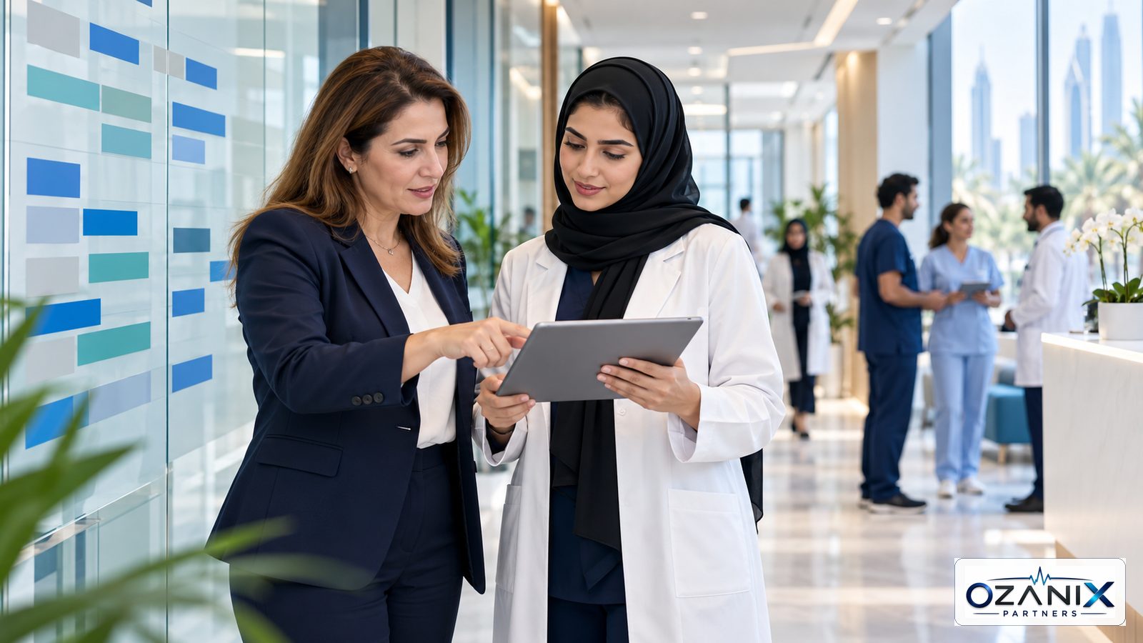 Clinic HR manager and Emirati healthcare professional reviewing a workforce plan in a modern UAE clinic