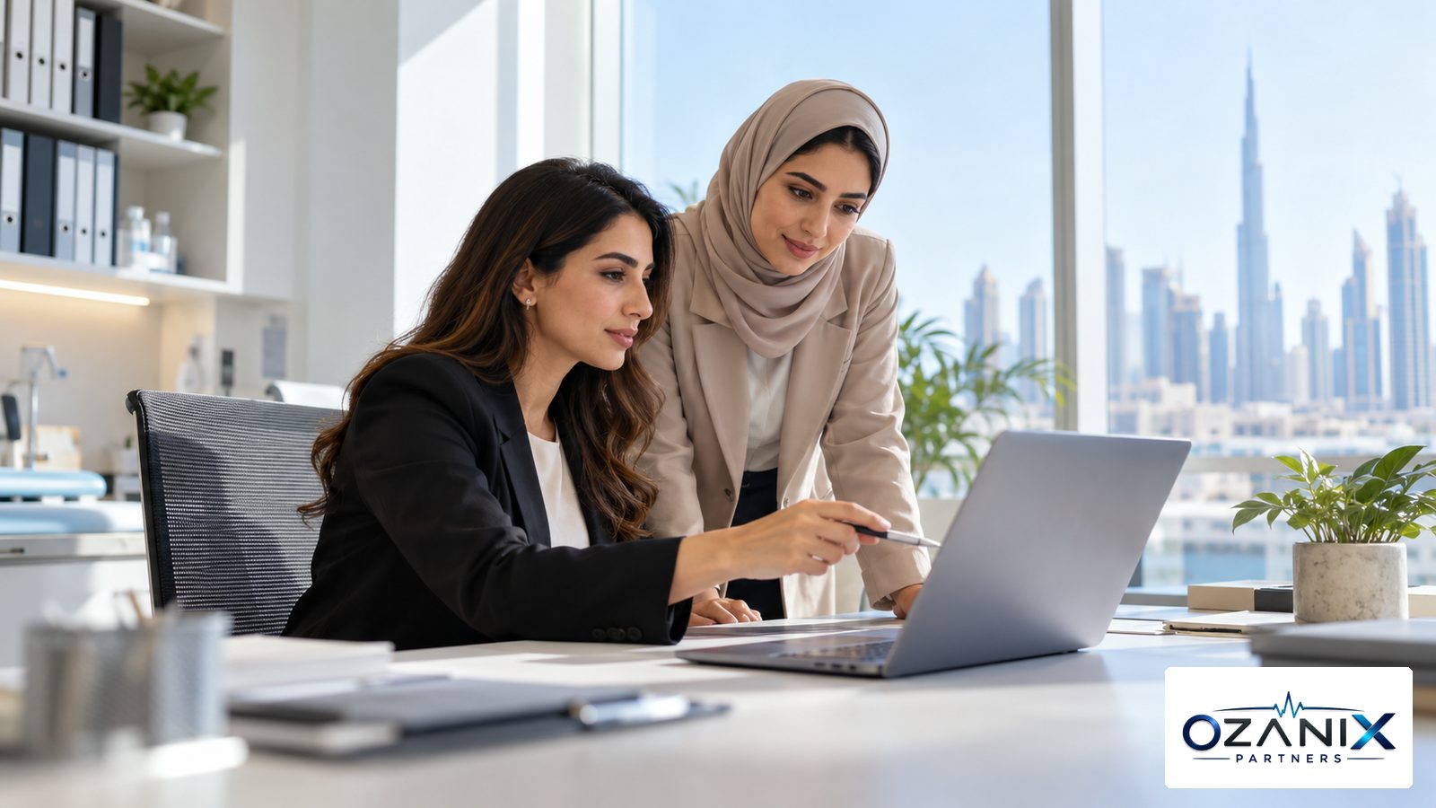 A clinic finance manager reviews a monthly payroll summary on a laptop in a bright Dubai clinic back office